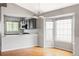Kitchen and dining area featuring stainless steel appliances and hardwood flooring at 7680 Elmwood St, Littleton, CO 80125