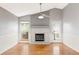 Bright living room featuring a fireplace, ceiling fan, and hardwood floors at 7680 Elmwood St, Littleton, CO 80125
