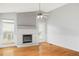 Light-filled living room featuring a fireplace, ceiling fan, and hardwood floors at 7680 Elmwood St, Littleton, CO 80125