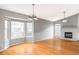 Spacious living room with a fireplace, large windows, and hardwood flooring at 7680 Elmwood St, Littleton, CO 80125