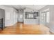 Open-concept space with hardwood floors connecting the living and dining areas at 7680 Elmwood St, Littleton, CO 80125