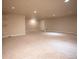 Spacious finished basement with neutral carpet, recessed lighting, and ample room for entertaining and storage at 25669 E Fair Dr, Aurora, CO 80016