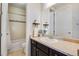 Bathroom with a vanity featuring dark wood cabinets, a white sink and white tiled bath at 25669 E Fair Dr, Aurora, CO 80016