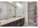 A bathroom featuring double sinks, a spacious vanity, and a shower-tub combo at 25669 E Fair Dr, Aurora, CO 80016