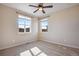 A light-filled bedroom with two windows providing ample natural light and neutral-toned walls at 25669 E Fair Dr, Aurora, CO 80016