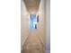 Neutral hallway leading to a room with a view, featuring carpeted floors and recessed lighting at 25669 E Fair Dr, Aurora, CO 80016