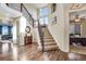 Hallway with hardwood floors leading to the staircase with iron railings at 25669 E Fair Dr, Aurora, CO 80016