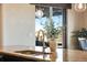 Modern kitchen featuring granite countertops and a view from the large windows over the sink at 25669 E Fair Dr, Aurora, CO 80016