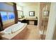 Bright bathroom showcasing a soaking tub, a vanity with a makeup area, and a glass-enclosed shower at 25669 E Fair Dr, Aurora, CO 80016