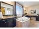 Spa-like bathroom with tub, double vanity and shower at 25669 E Fair Dr, Aurora, CO 80016