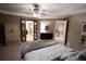 Bright main bedroom with carpet, ceiling fan, ensuite bath with sliding door and large walk-in closet at 25669 E Fair Dr, Aurora, CO 80016