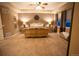 Spacious main bedroom featuring a ceiling fan, carpeted floor, and two bedside tables with lamps at 25669 E Fair Dr, Aurora, CO 80016