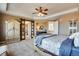 Large main bedroom with unique barn door access to en-suite bathroom at 25669 E Fair Dr, Aurora, CO 80016