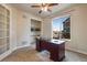 Bright home office with built-in shelving and large window at 25669 E Fair Dr, Aurora, CO 80016