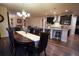 Open concept layout with a kitchen island, dining area, and living room at 25669 E Fair Dr, Aurora, CO 80016