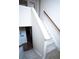 Carpeted staircase with white banister and wooden handrail at 25669 E Fair Dr, Aurora, CO 80016