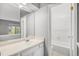 Brightly lit bathroom with a vanity, a large mirror, and an entrance to a full bathtub and toilet at 4621 S Fraser Cir # B, Aurora, CO 80015