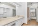 Bright bathroom with a large mirror, vanity, and a shower with sliding door leading to other parts of the home at 4621 S Fraser Cir # B, Aurora, CO 80015
