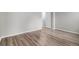 Spacious bedroom with hardwood flooring, a closet, and a door leading to other parts of the house at 4621 S Fraser Cir # B, Aurora, CO 80015
