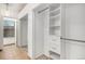 A closet with white built-in shelves and drawers for clothing storage is displayed in this photo at 4621 S Fraser Cir # B, Aurora, CO 80015