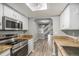 Stylish kitchen with stainless steel appliances and open access to the staircase at 4621 S Fraser Cir # B, Aurora, CO 80015