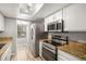 Modern kitchen equipped with stainless steel appliances and a breakfast nook at 4621 S Fraser Cir # B, Aurora, CO 80015