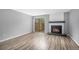 Bright living room with hardwood floors, fireplace, and sliding glass door at 4621 S Fraser Cir # B, Aurora, CO 80015