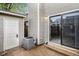 Exterior patio with a sliding glass door, small storage shed, air conditioning unit and cement floors at 4621 S Fraser Cir # B, Aurora, CO 80015