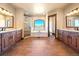 A luxurious bathroom features dual vanities, a soaking tub, and a glass enclosed shower at 1552 Colt Cir, Castle Rock, CO 80109