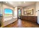 This bathroom boasts a soaking tub under an arched window and dual sink vanity at 1552 Colt Cir, Castle Rock, CO 80109