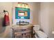 A rustic bathroom features a unique vanity and a vintage mirror with charming character at 1552 Colt Cir, Castle Rock, CO 80109
