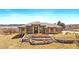 Beautiful single Gathering home with grand entryway, stone accents, and a landscaped front yard on a sunny day at 1552 Colt Cir, Castle Rock, CO 80109