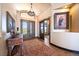 Elegant foyer with hardwood floors, high ceilings, custom doors, and a beautiful rug with a center table at 1552 Colt Cir, Castle Rock, CO 80109
