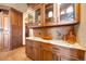 A custom kitchen features wood cabinetry with glass uppers and marble countertops at 1552 Colt Cir, Castle Rock, CO 80109