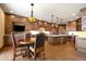 Eat-in kitchen includes wooden cabinets, stone countertops, a center island, and a breakfast table at 1552 Colt Cir, Castle Rock, CO 80109