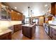 Gourmet kitchen offers granite countertops, custom cabinets, and an island with pendant lighting at 1552 Colt Cir, Castle Rock, CO 80109