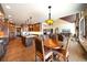Open concept kitchen featuring an island, custom cabinets, and hardwood floors leading to living room at 1552 Colt Cir, Castle Rock, CO 80109