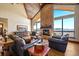 Inviting living room with a stone fireplace, vaulted ceilings, hardwood floors, and mountain views at 1552 Colt Cir, Castle Rock, CO 80109