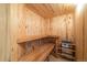 An interior view of the home's wooden sauna, complete with built-in benches and heating element at 1552 Colt Cir, Castle Rock, CO 80109