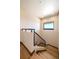 Beautiful interior stairs with hardwood treads, railing, and natural light at 1552 Colt Cir, Castle Rock, CO 80109