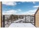 Spacious balcony with black railings overlooking a scenic neighborhood on a sunny day at 15475 Andrews Dr # 412, Denver, CO 80239