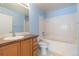 Traditional bathroom with a built-in tub, vanity, and blue painted walls at 15475 Andrews Dr # 412, Denver, CO 80239