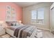 Cozy bedroom with a large window, bed, and neutral color palette at 15475 Andrews Dr # 412, Denver, CO 80239