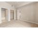 Neutral bedroom featuring three doorways, a large closet, and natural light at 15475 Andrews Dr # 412, Denver, CO 80239
