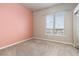 Empty bedroom featuring a large window and neutral color palette at 15475 Andrews Dr # 412, Denver, CO 80239