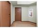 Apartment hallway with unit entry doors and a recessed fire extinguisher box at 15475 Andrews Dr # 412, Denver, CO 80239