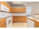 Efficient kitchen with modern appliances, wood cabinets, and ample counter space at 15475 Andrews Dr # 412, Denver, CO 80239