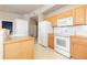 Bright kitchen with wood cabinets and modern appliances at 15475 Andrews Dr # 412, Denver, CO 80239