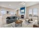 Bright living room features a fireplace, neutral decor, and comfortable seating at 15475 Andrews Dr # 412, Denver, CO 80239