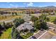 Stunning aerial view of a property boasting a pool, lush landscaping, and picturesque mountain views in the background at 750 Copper Ln # 102, Louisville, CO 80027